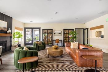 a living room with leather furniture and a fireplace